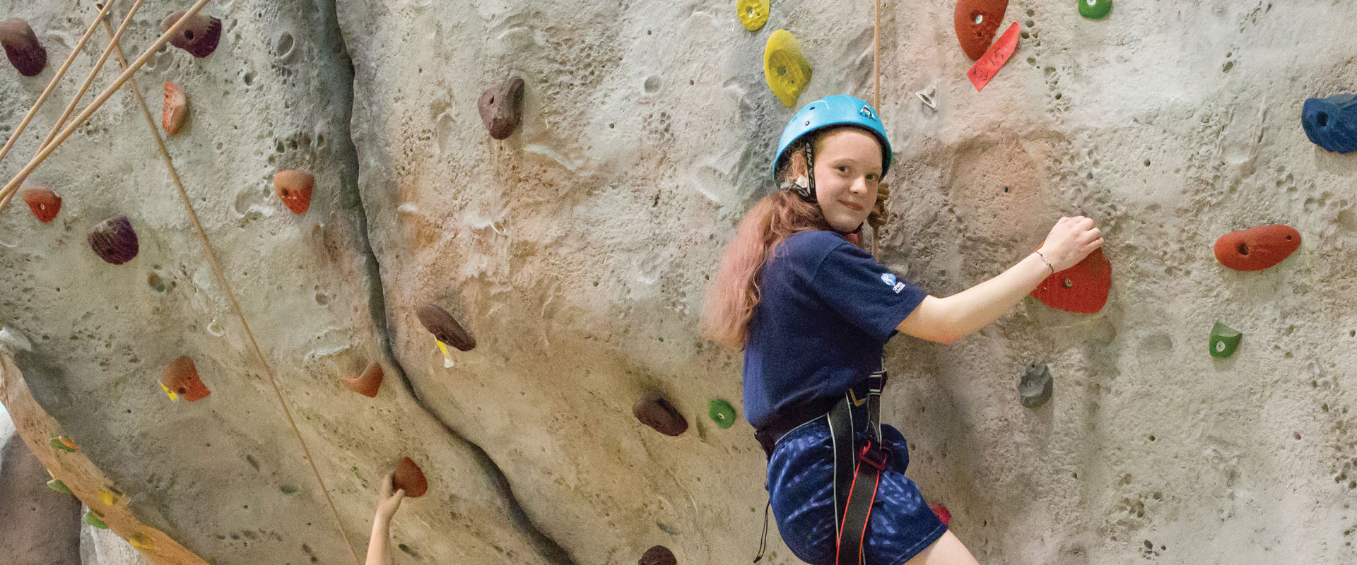 Student climbing wall